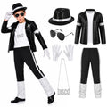 Child wearing a black sequin decorated jacket pants white top hat glasses gloves and DISCO necklace.