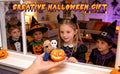 A clear product view presents a light-up masked horror figure holding a glowing jack-o'-lantern, with the masked figure, orange jack-o'-lantern and internal glow clearly visible.