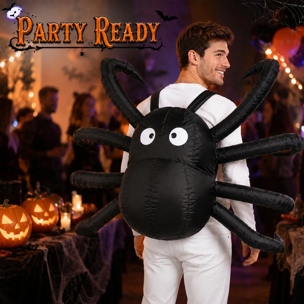 Adult wearing the Light-Up inflatable spider costume in a Halloween-themed setting with orange lights and party decorations.