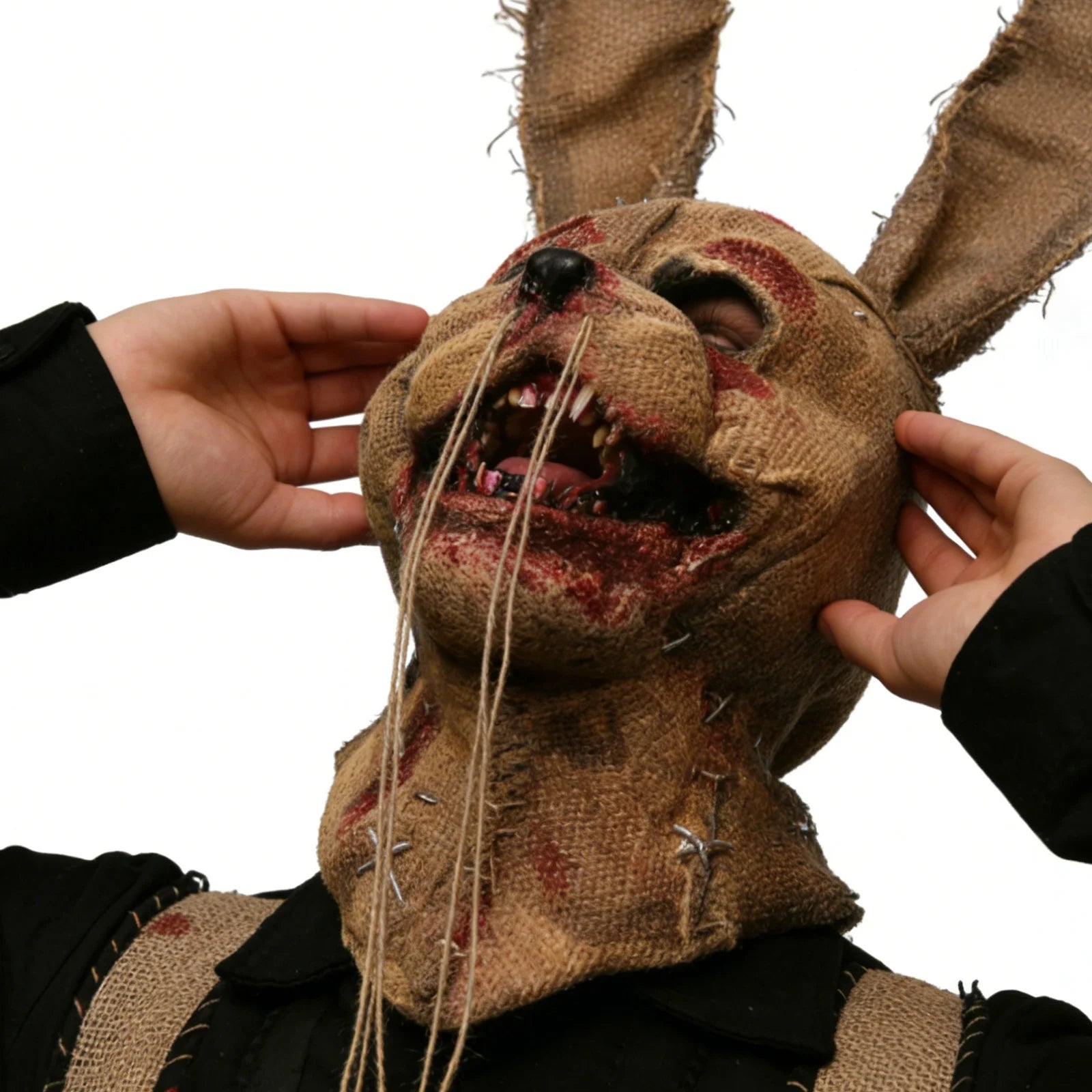 Long-eared scarecrow rabbit mask is shown from the back, with the long ears, distressed burlap, stitched face and exposed teeth visible.