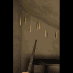 Magic wand controlling floating LED candles hanging from the ceiling for magical room decor, Halloween party, and themed event decorations.