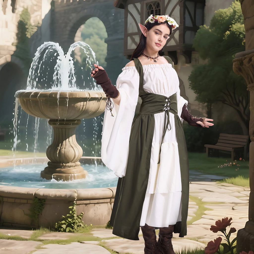 Woman in an army green medieval elf dress with pointed ears and arm cuffs beside a courtyard fountain