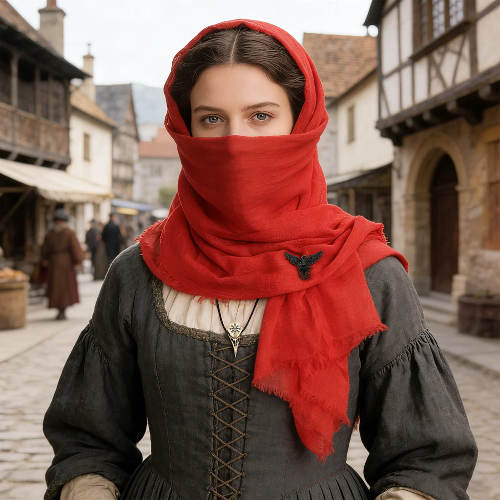 Woman styling the red medieval hooded scarf as a face covering