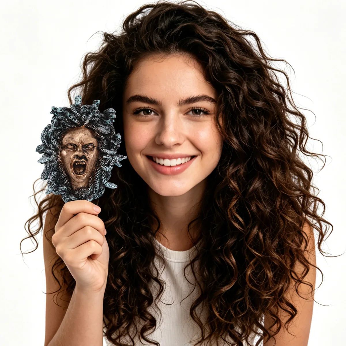 Adult holds the Medusa wall ornament to show its compact scale.