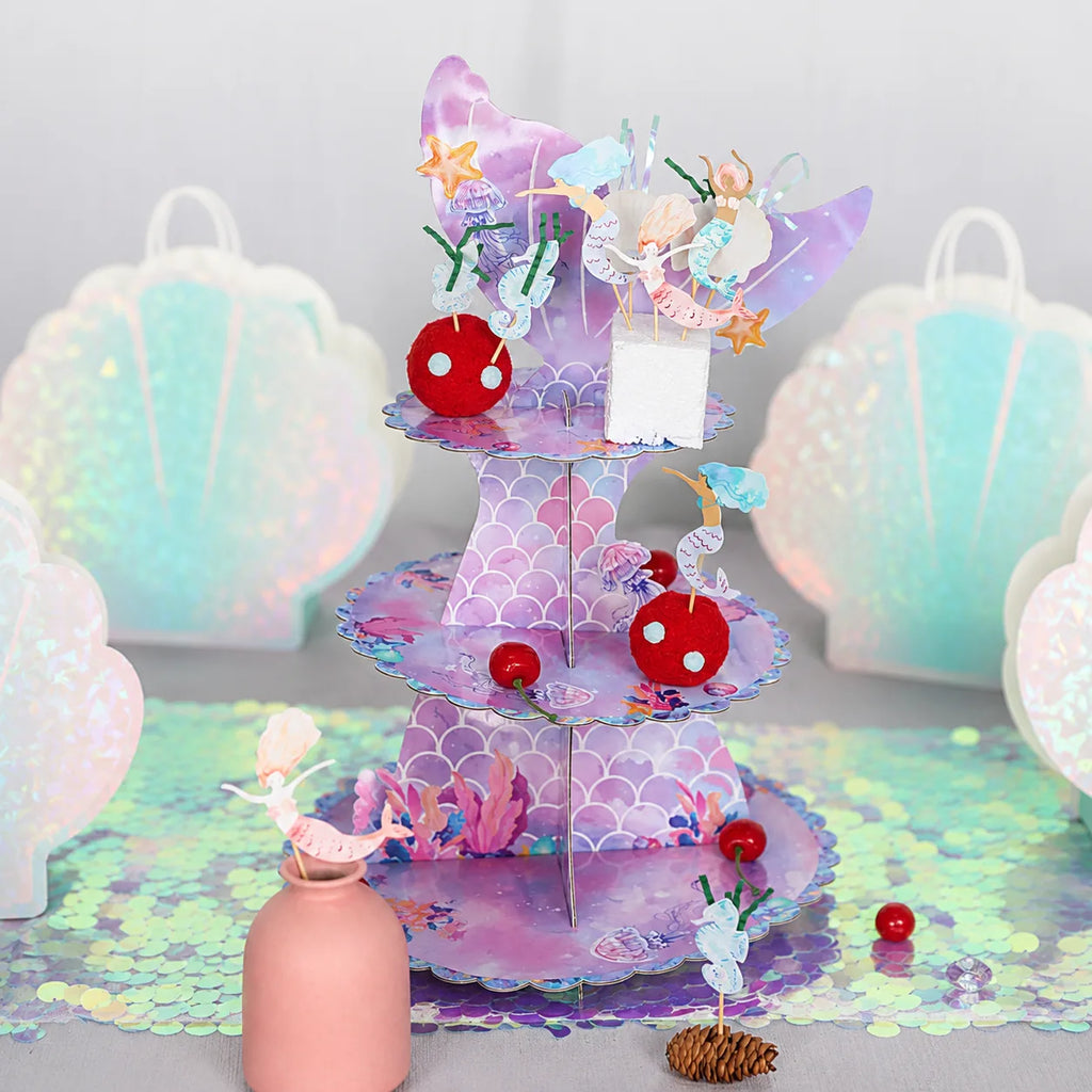 Mermaid cake stand with dessert toppers for mermaid birthday party table decorations
