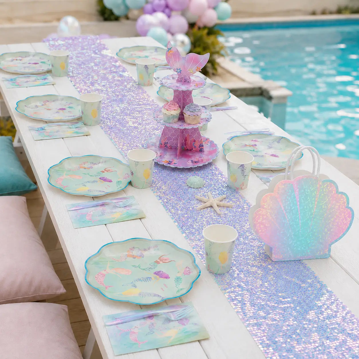 Mermaid themed party tableware for 8 guests with paper plates, cups, napkins, cutlery, table runner and cake stand