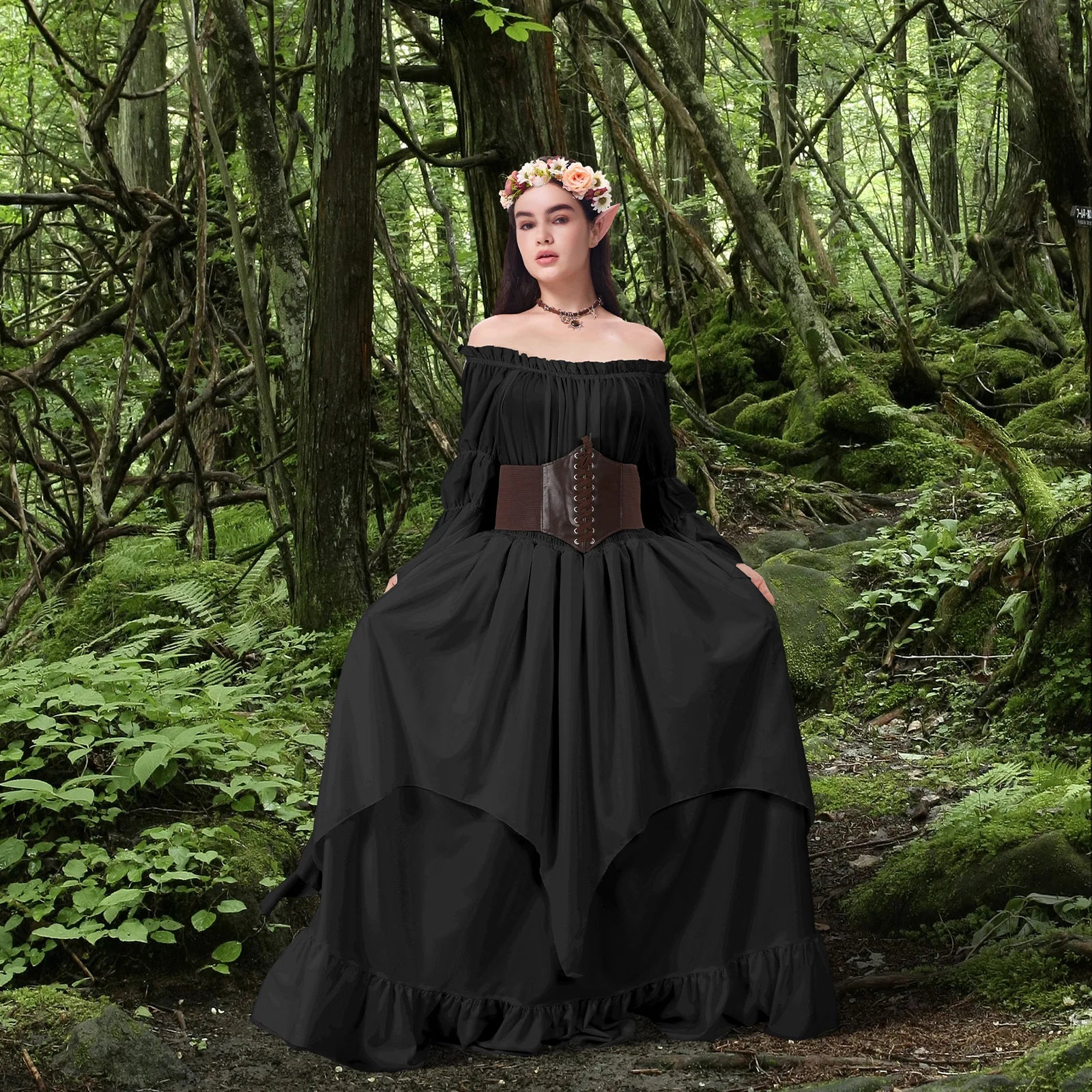 Woman wearing a midnight black Renaissance fairy costume with corset belt and floral crown in a woodland setting