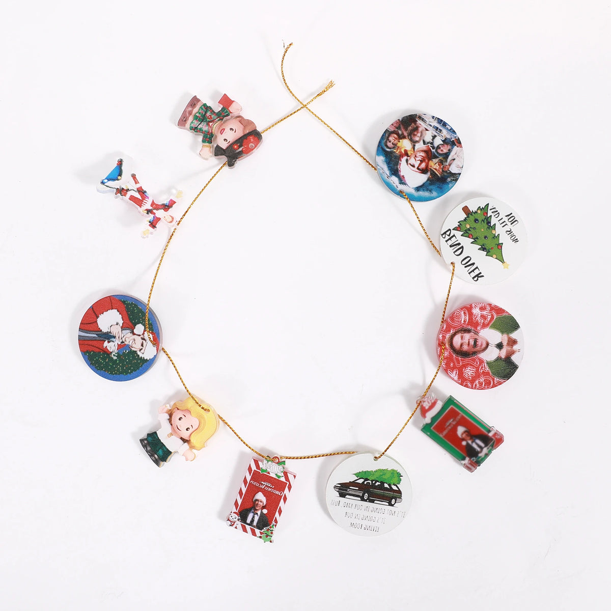 Christmas Vacation and Elf themed flat charms threaded along gold cord on a white background.