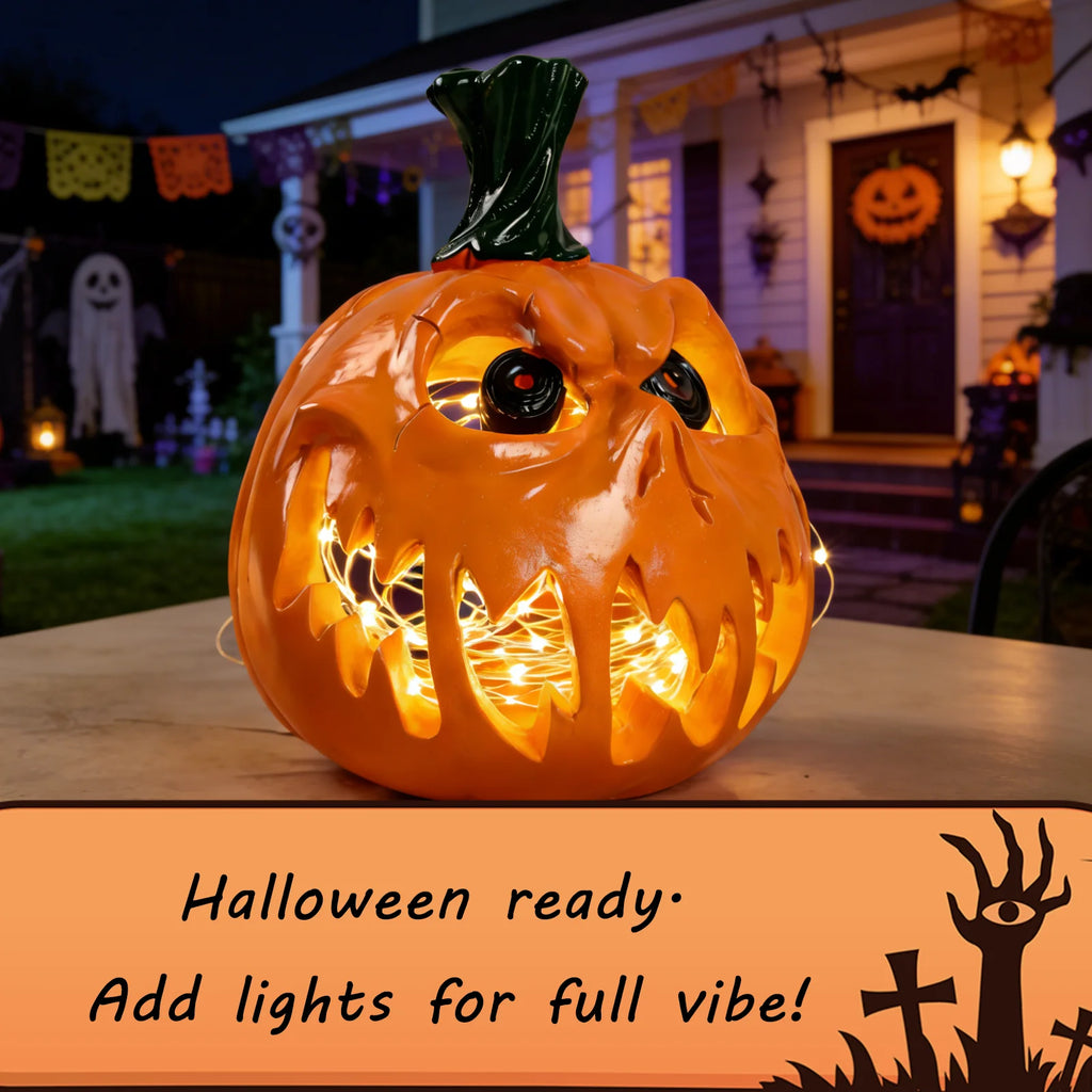 A clear product view presents a openwork pumpkin figurine styled with added lights, with the glossy orange finish, fanged face and open interior clearly visible.