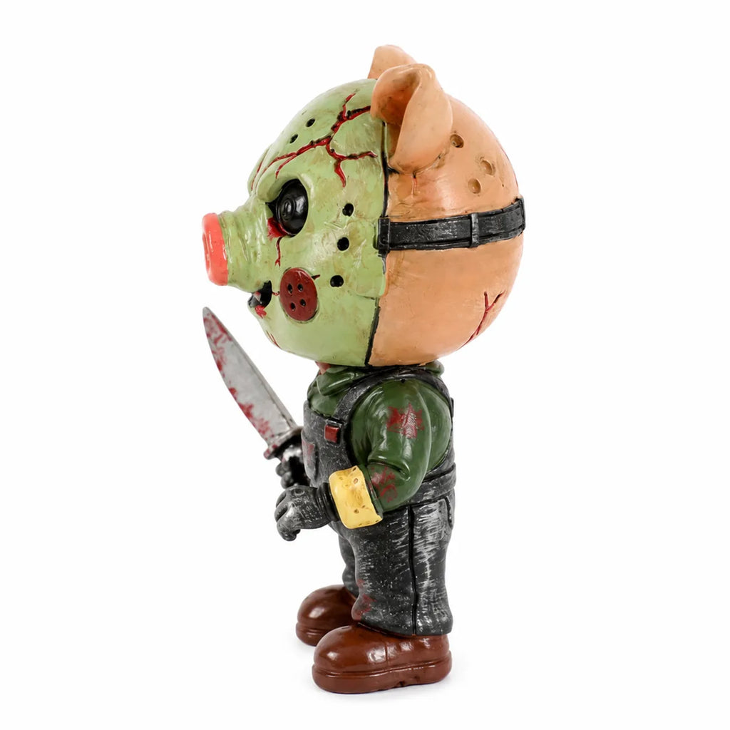 Side view of the pig mask horror figurine, showing its profile and visible construction details.