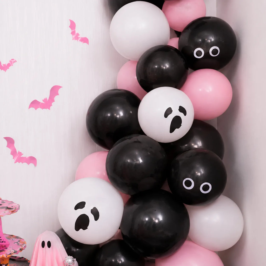 Pink, black and white Halloween balloon garland with ghost face balloons