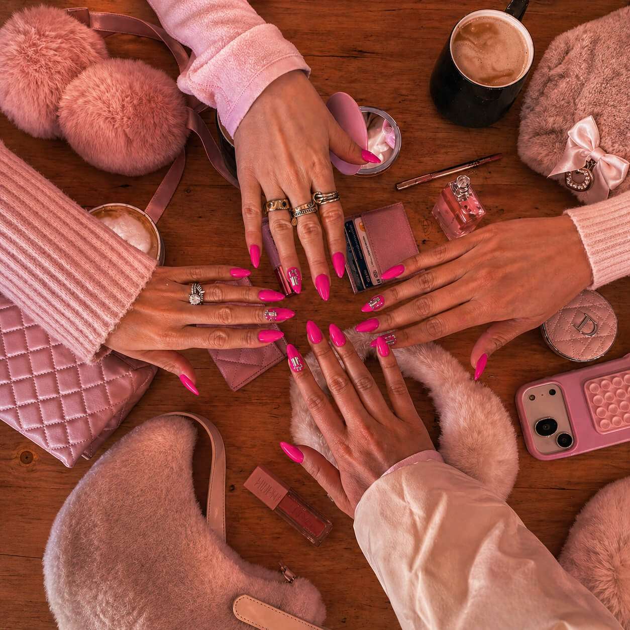 Pink girls night spa party scene with manicured nails, cozy slippers, beauty accessories, pink bags and pamper party decor