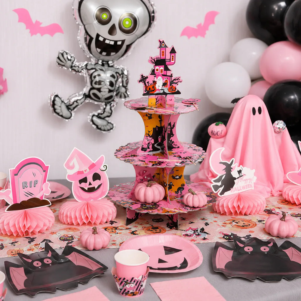 Pink Halloween 3-tier cupcake stand with pumpkin plates, bat plates, mini pumpkins and table decorations