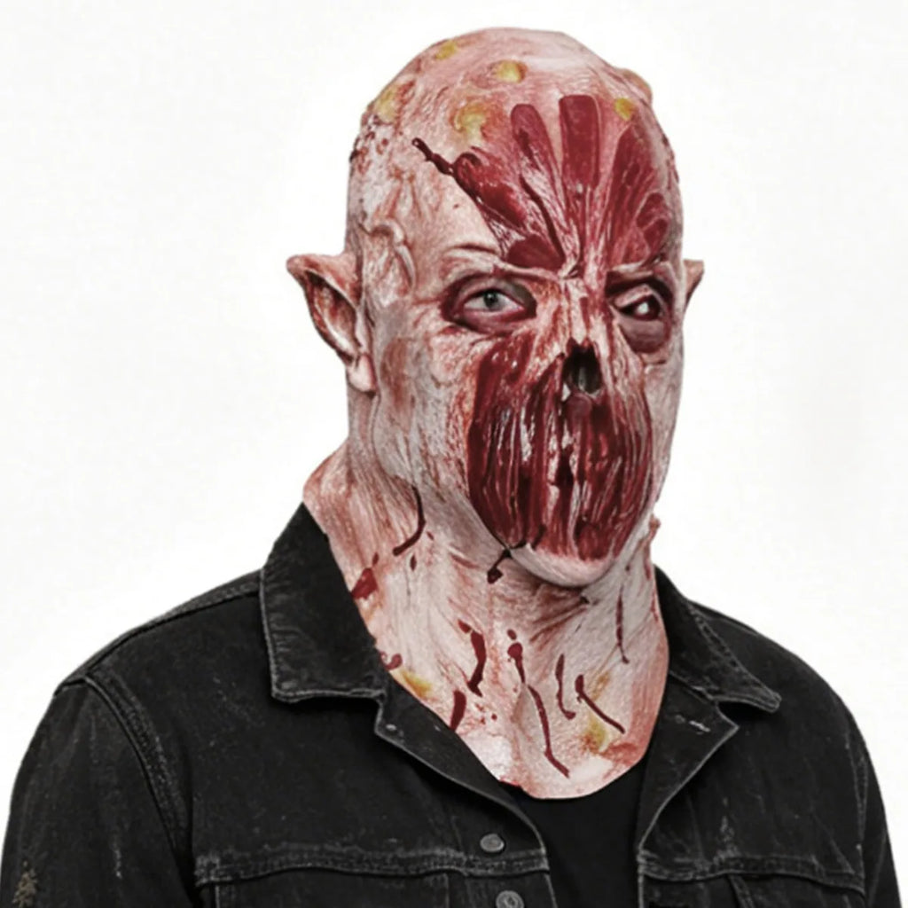 Three-quarter worn view of the pink lipless horror mask shows the pointed ears and neck coverage.
