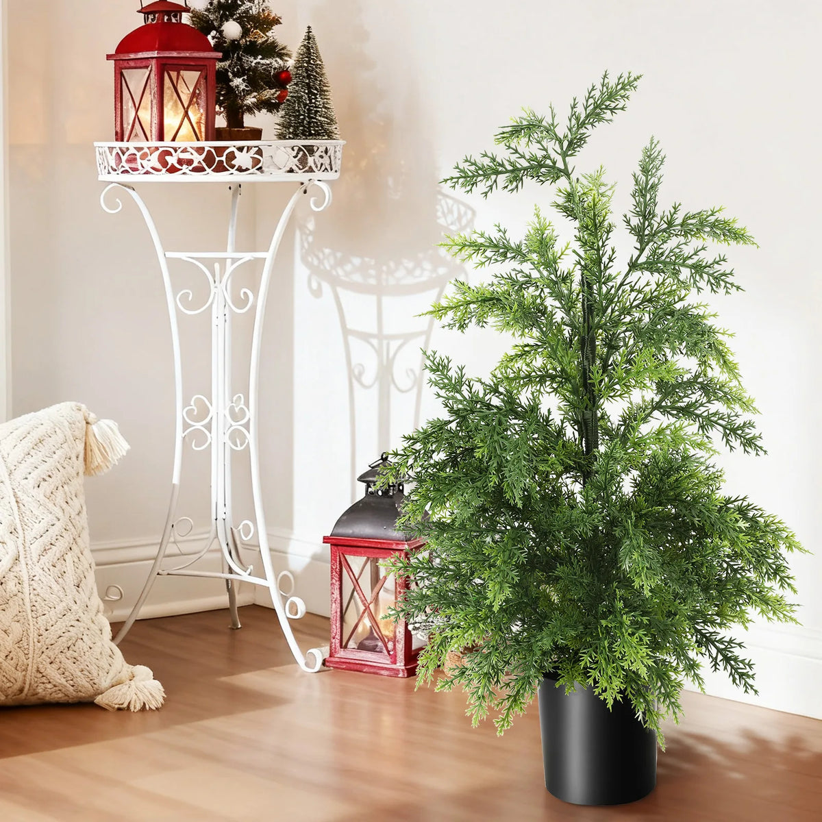 The potted tree appears beside a red lantern and a white decorative stand.