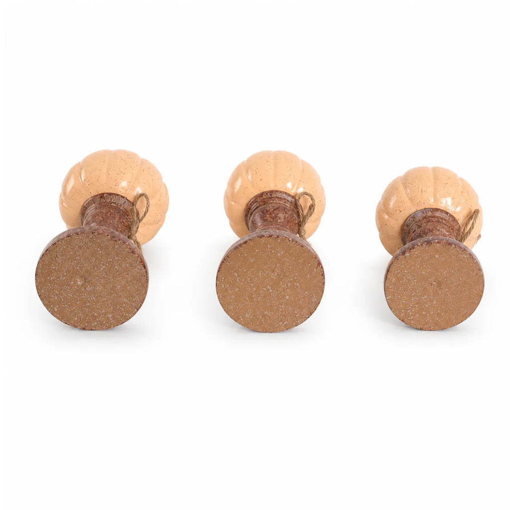 Multiple-angle view of the pumpkin candle holder set, showing its shape from different sides.