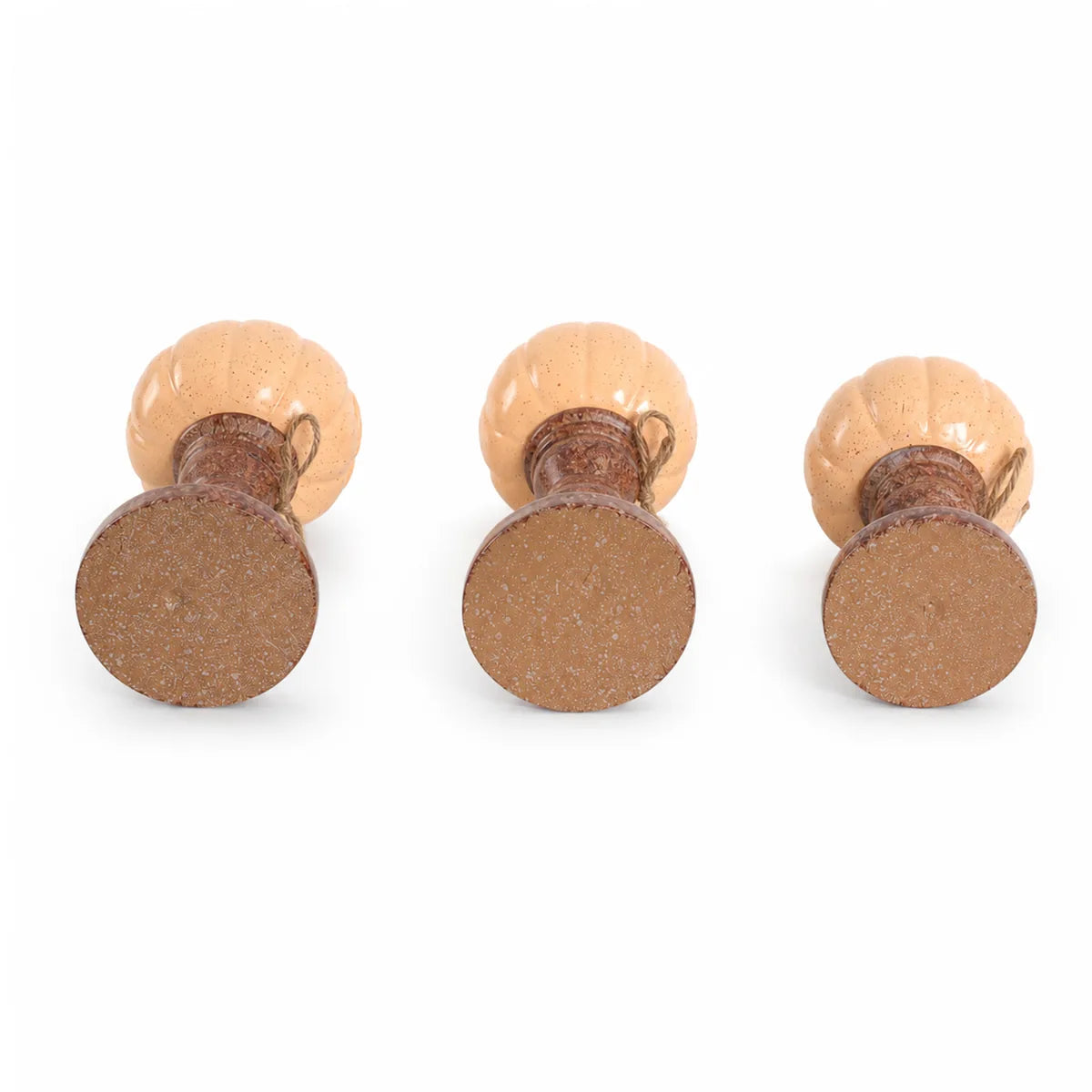 Multiple-angle view of the pumpkin candle holder set, showing its shape from different sides.