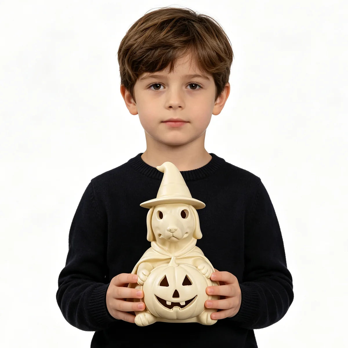 Child holds the cream pumpkin ghost dog lamp to show scale.