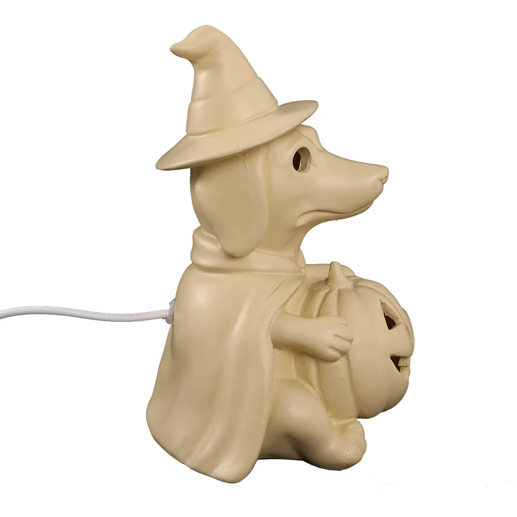 Side view shows the witch hat, cape, pumpkin, and USB cord.