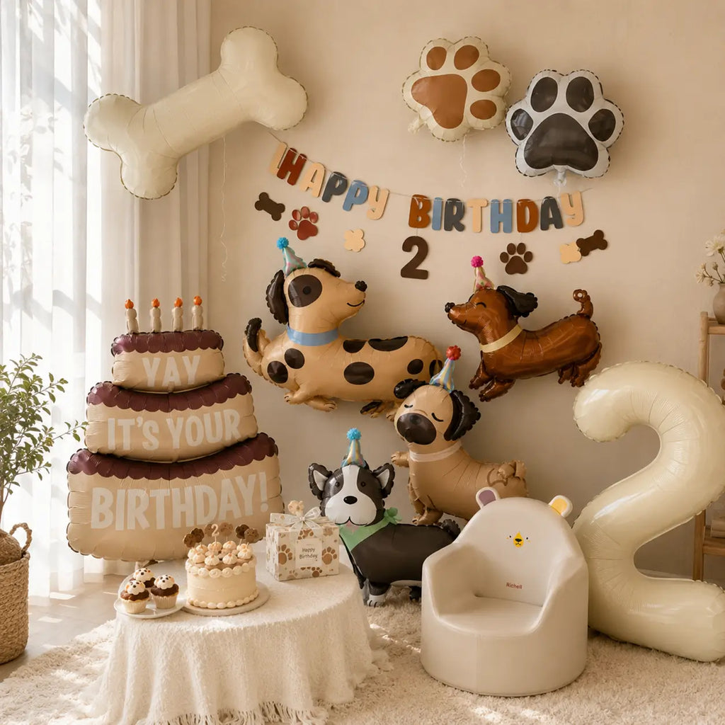 Puppy birthday party balloon display with dog shaped balloons, paw print balloons, bone balloon, birthday banner, cake, gift box, and number 2 decoration.