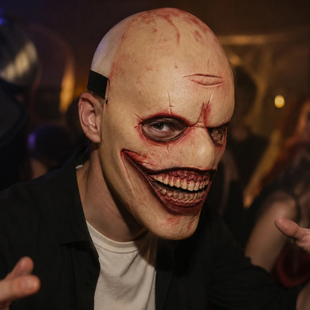 Model wearing the Bald Grinning Horror Mask in a Halloween costume setting