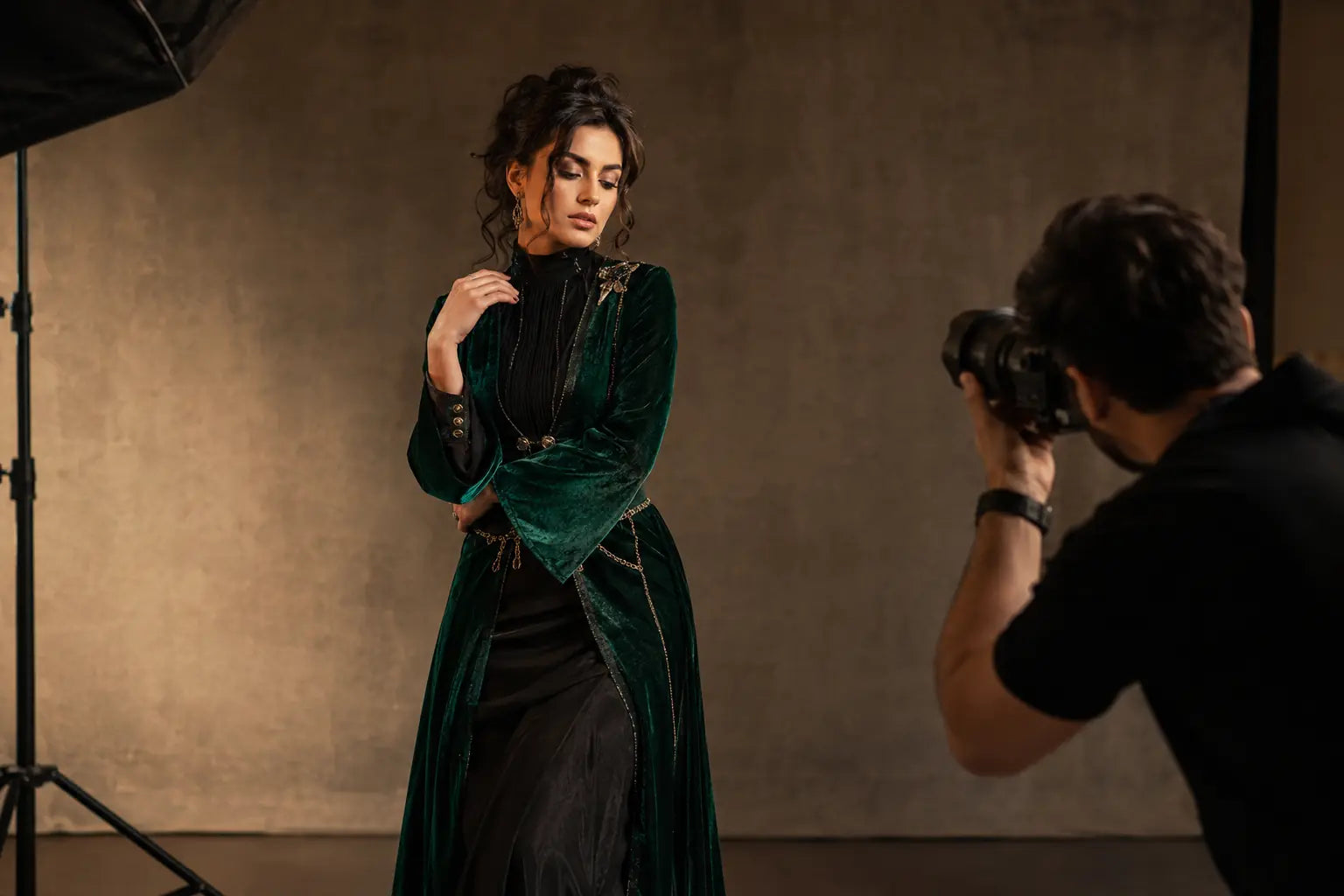 Model in an emerald and black editorial look photographed in a professional studio
