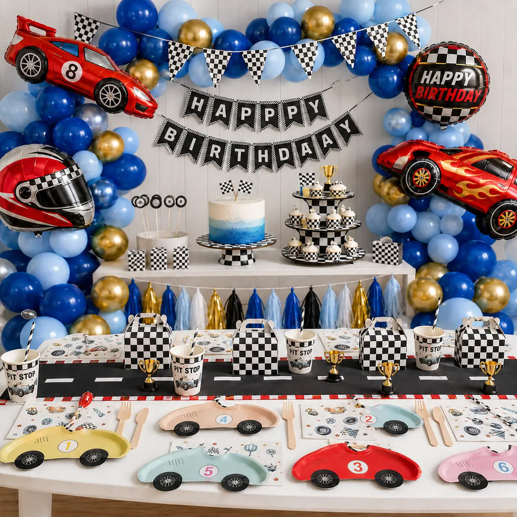 Race car birthday party decorations with a blue and gold balloon garland, checkered gift boxes and car-shaped plates