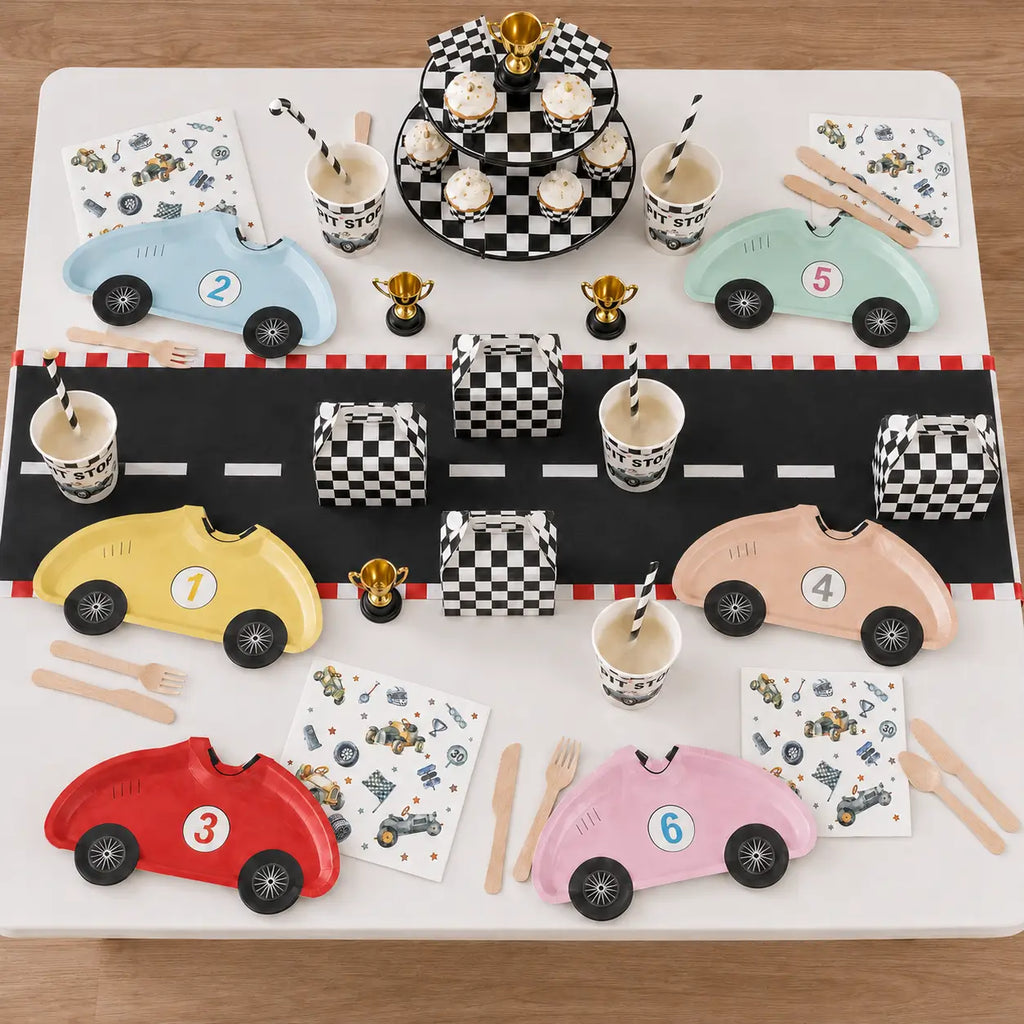 Overhead race car party tableware with car-shaped plates, vintage race car napkins, pit stop cups and wooden cutlery