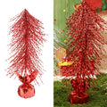 A red tabletop Christmas tree with a shiny wrapped base on white.
