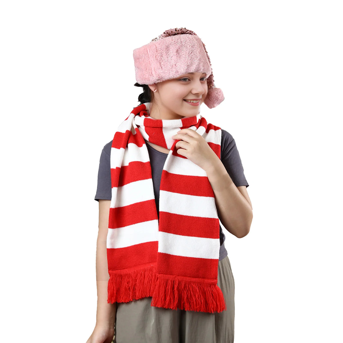 Smiling model wears the striped scarf on white for a holiday outfit.