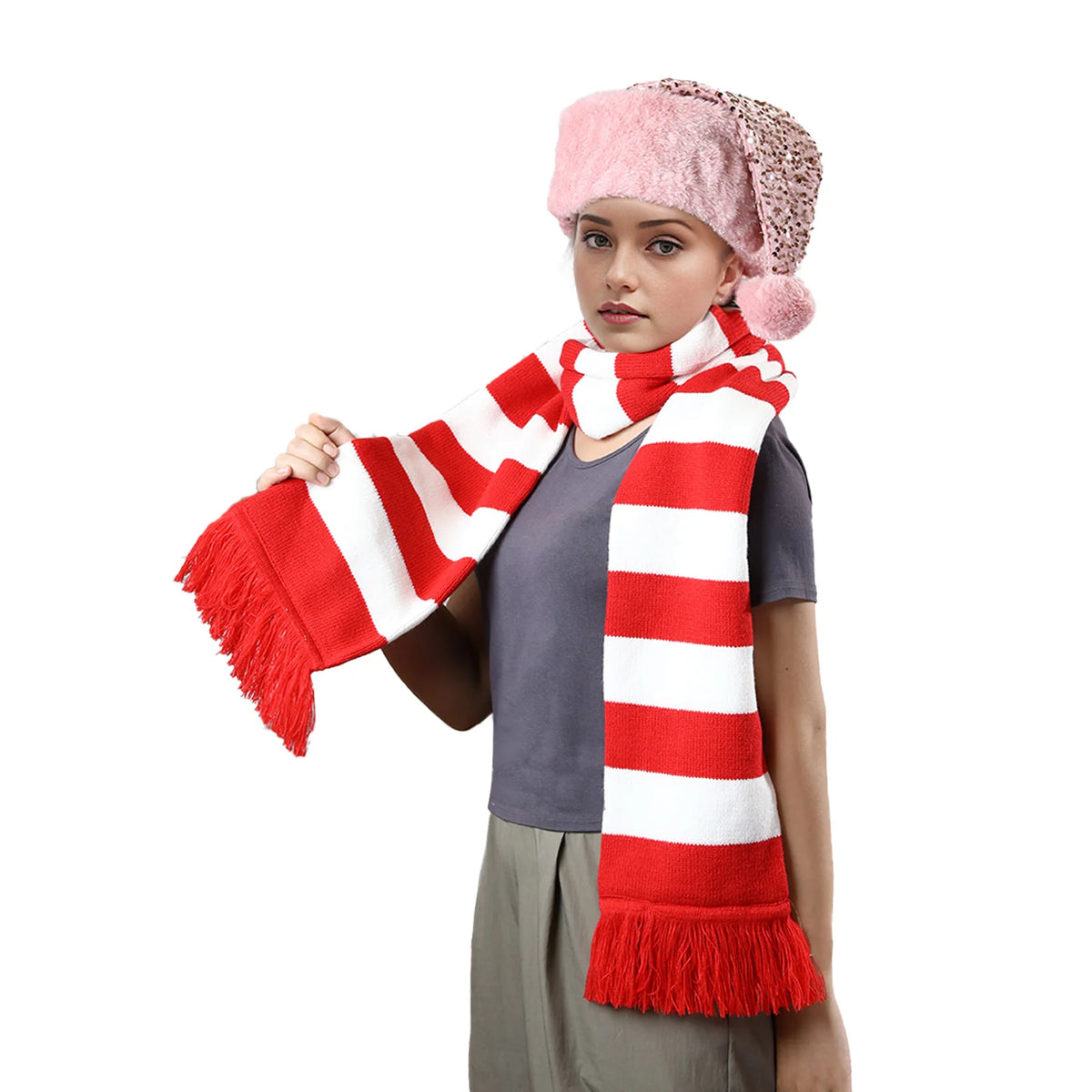 Model in a pink hat wears the striped scarf on white.
