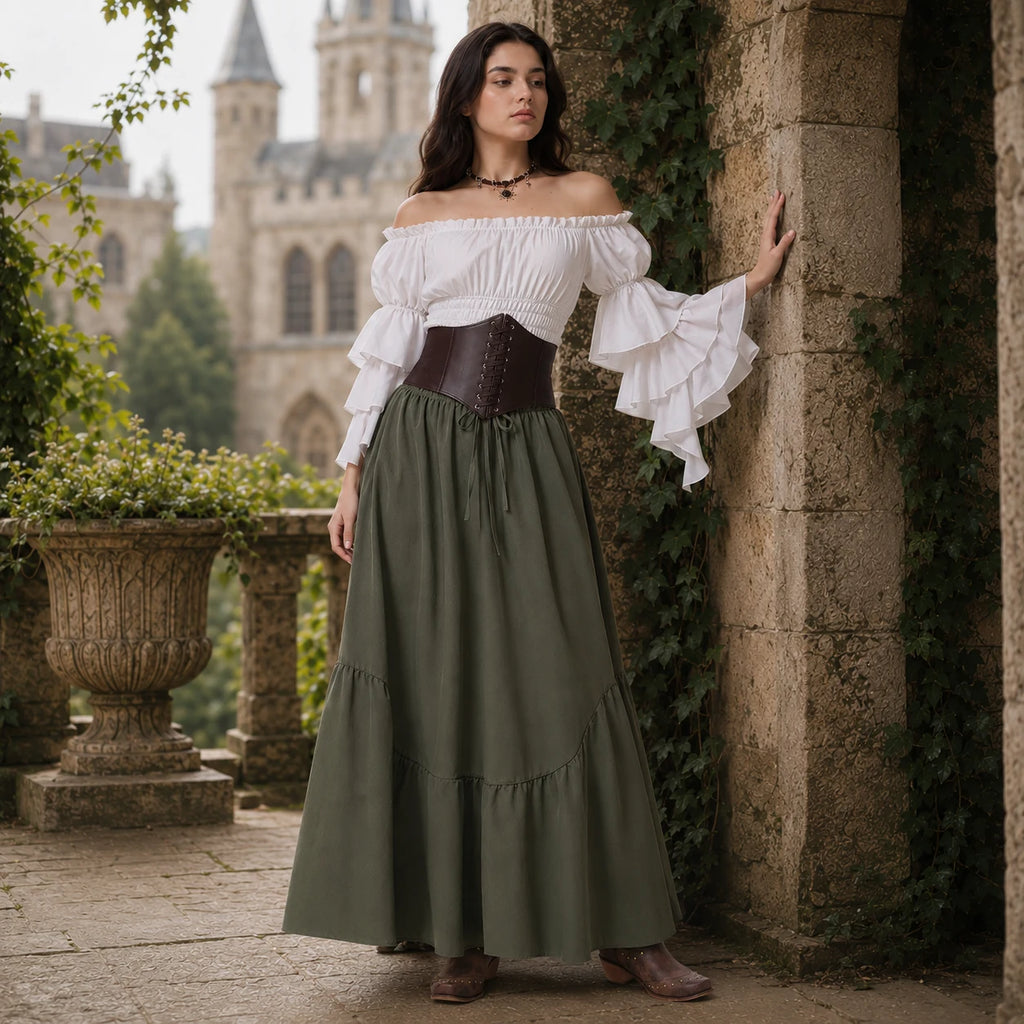 Woman in a white off-shoulder blouse and olive green skirt in a garden setting