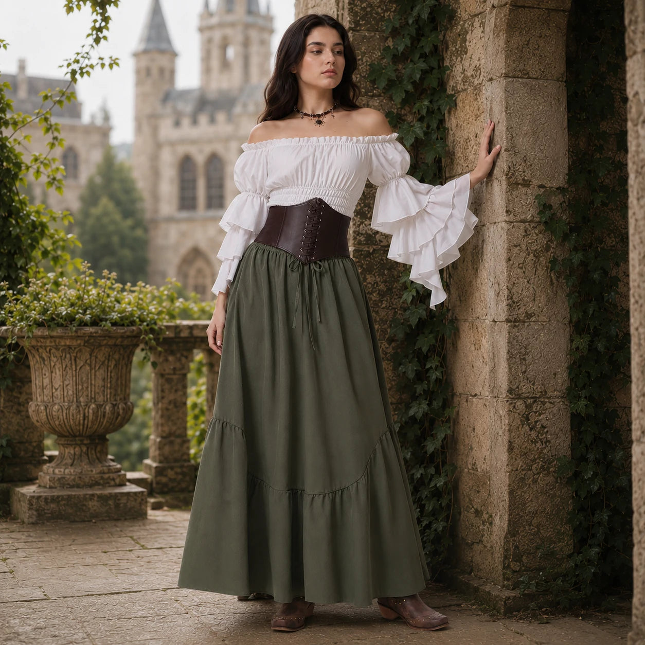 Woman in a white off-shoulder blouse and olive green skirt in a garden setting