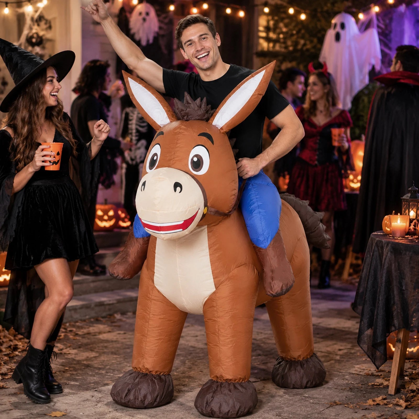 An adult wears the inflatable donkey costume outdoors during a colorful street carnival.