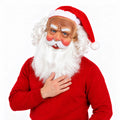 Santa mask with white beard and red hat worn by a model in red.