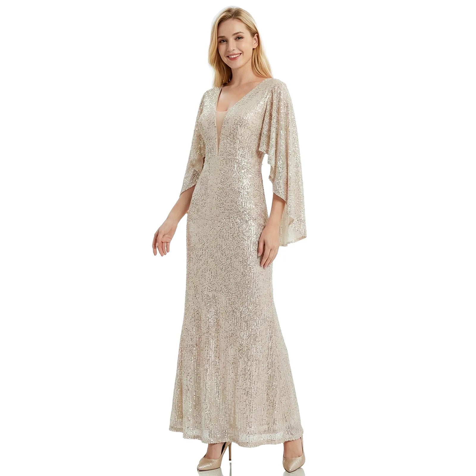 A woman models the silver champagne sequin mermaid gown with cape sleeves from the front against a white background, showing its overall silhouette.