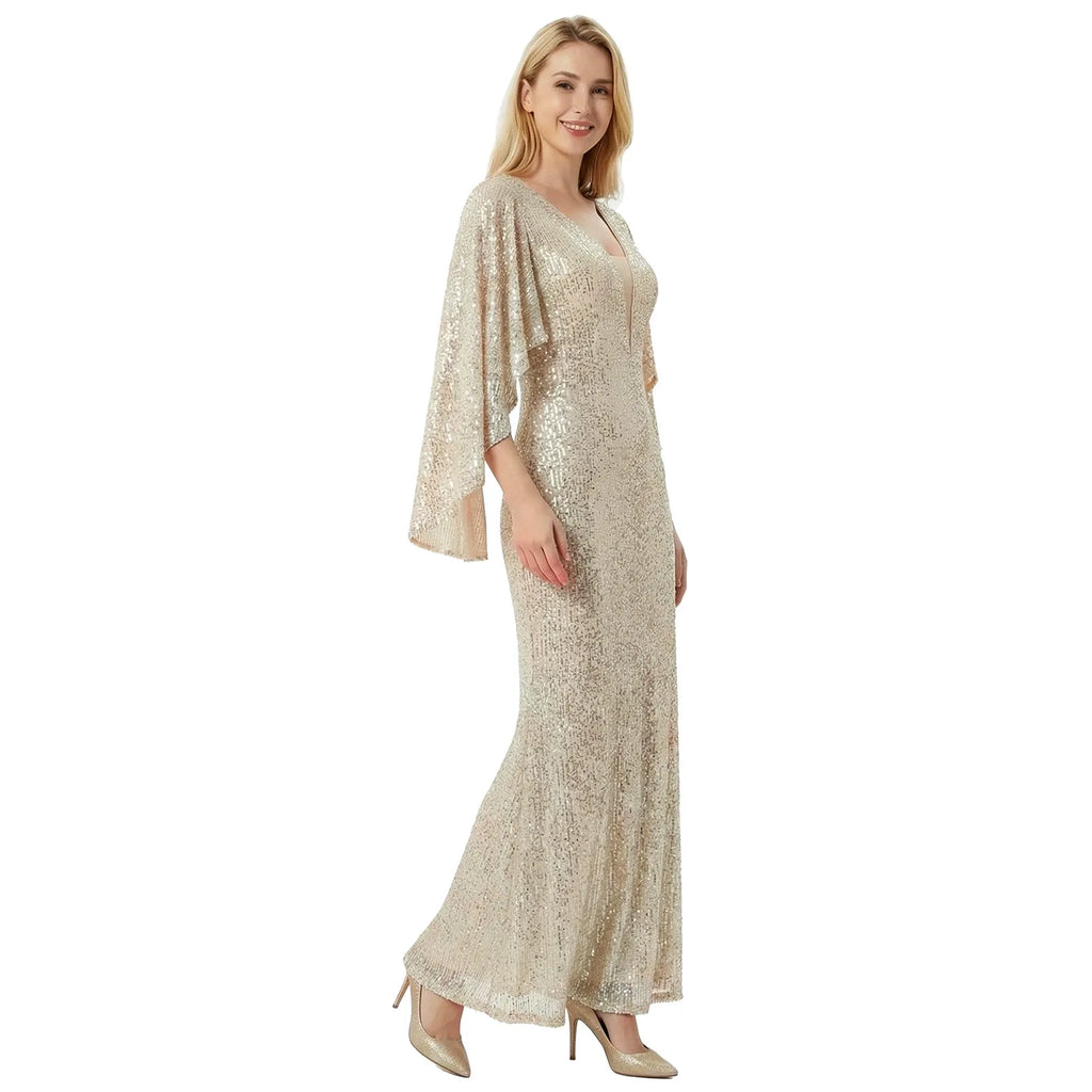 A woman models the silver champagne sequin mermaid gown in a walking front pose against a white background.