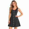A woman models the black-gray sleeveless denim dress with a button front and two patch pockets.