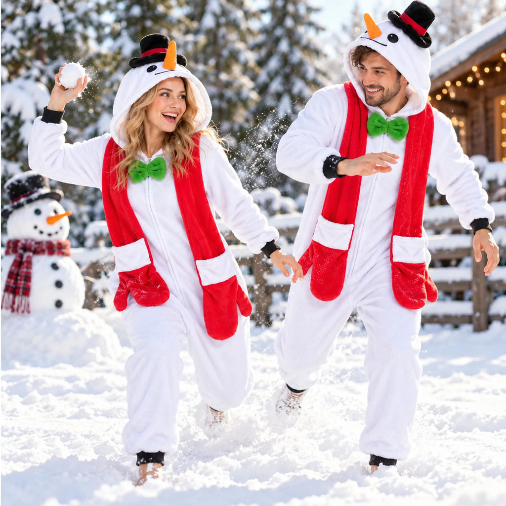 Two adults wear snowman onesies and red scarves in a snowy setting.