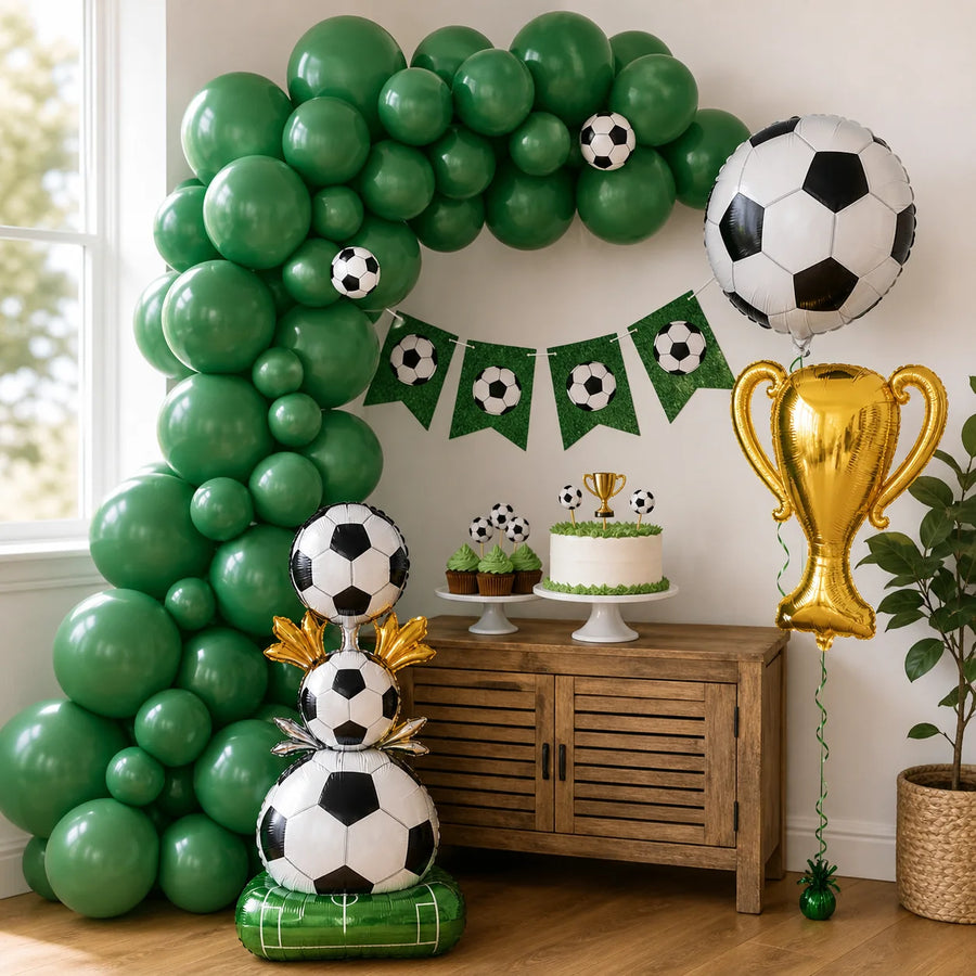 Soccer party decoration detail with solid green balloon garland trophy foil balloon soccer foil balloon and standing balloon display
