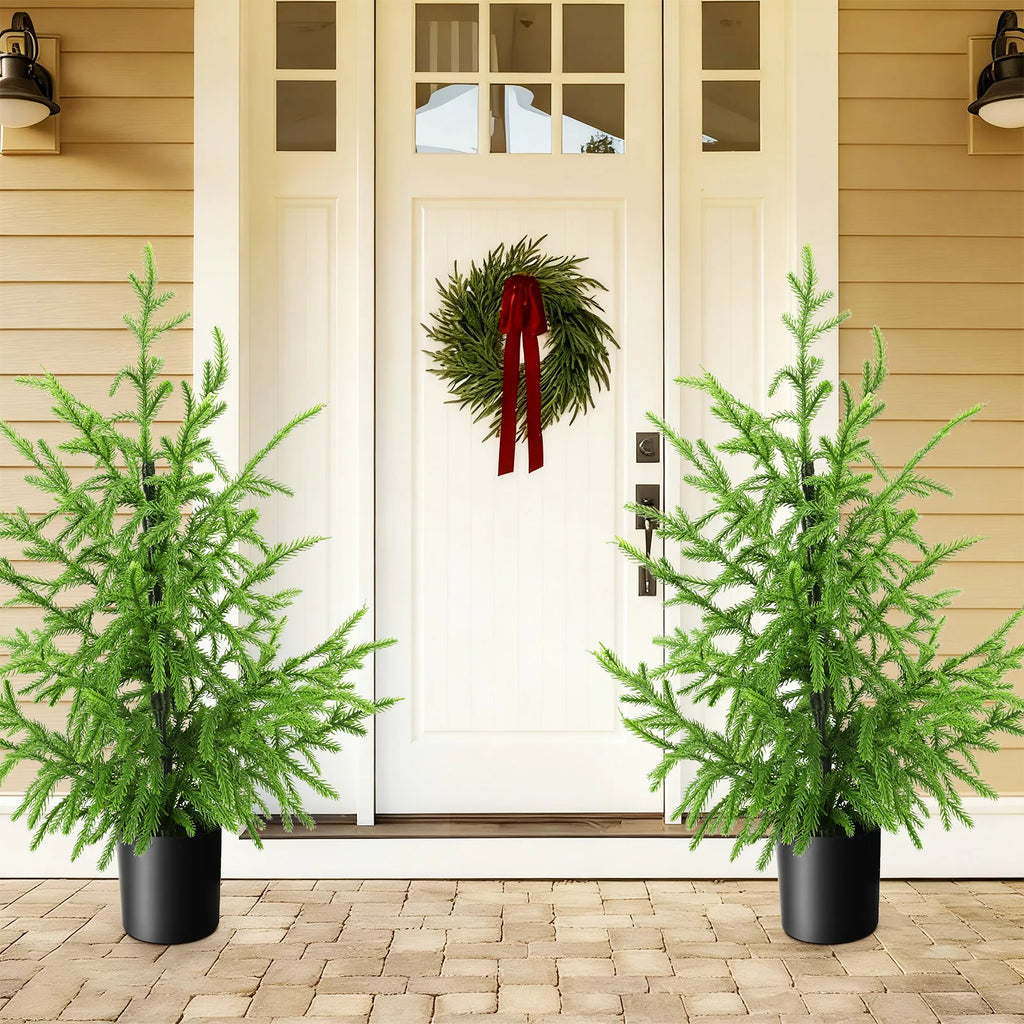 Two 60 cm potted trees frame a doorway in a display scene.