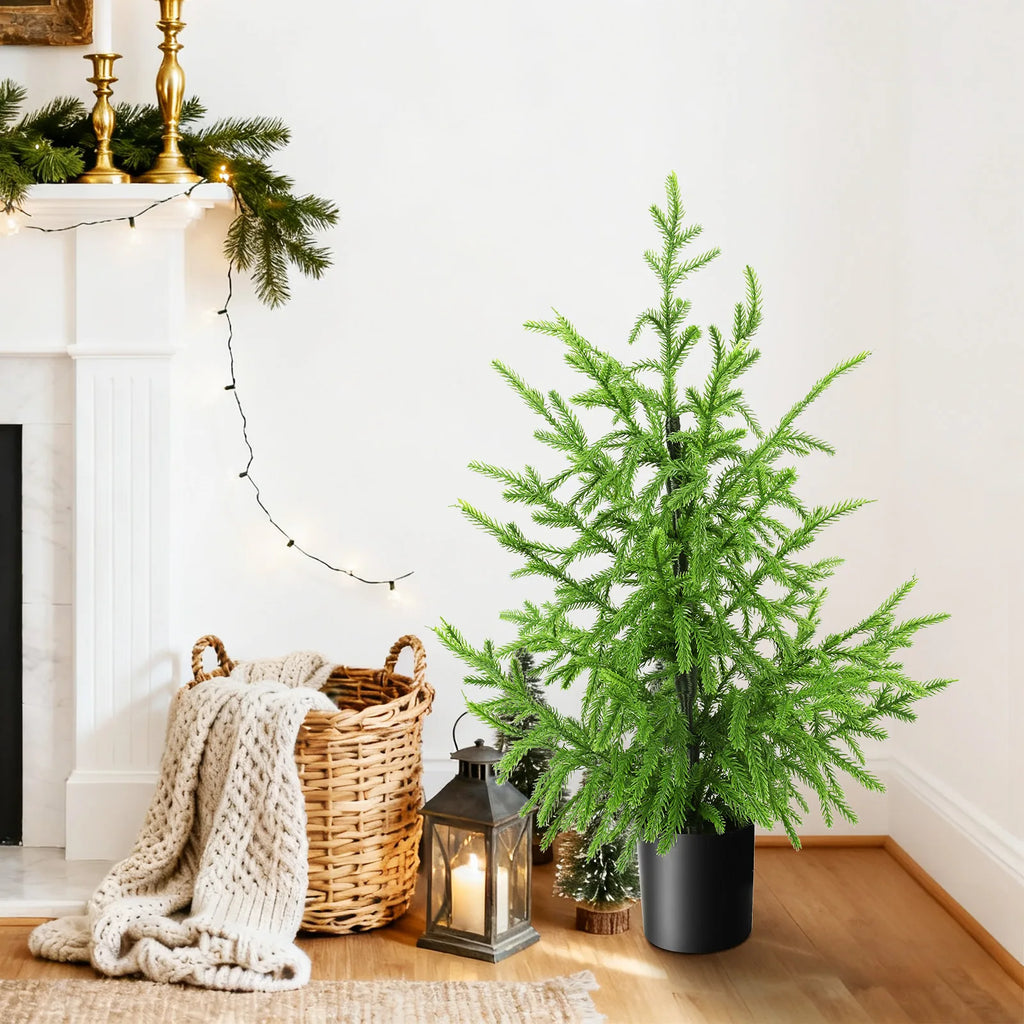 The 60 cm potted tree appears in a holiday setting.