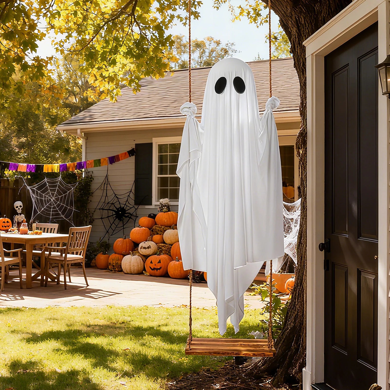 Non-lighted swinging ghost decoration on a Halloween porch