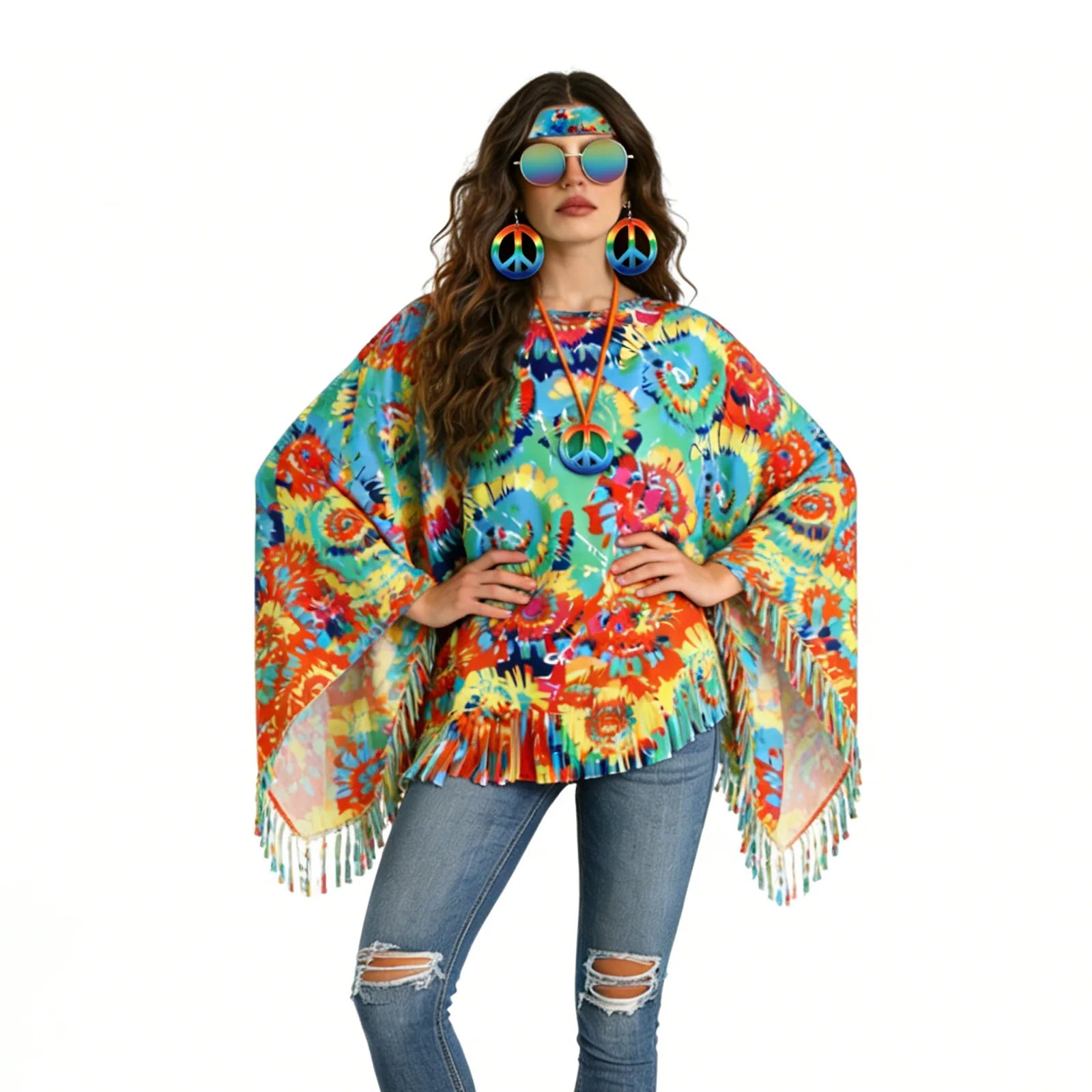 The hands-on-hips pose shows the poncho's wide draped sides, asymmetric points and long fringe against a white background.