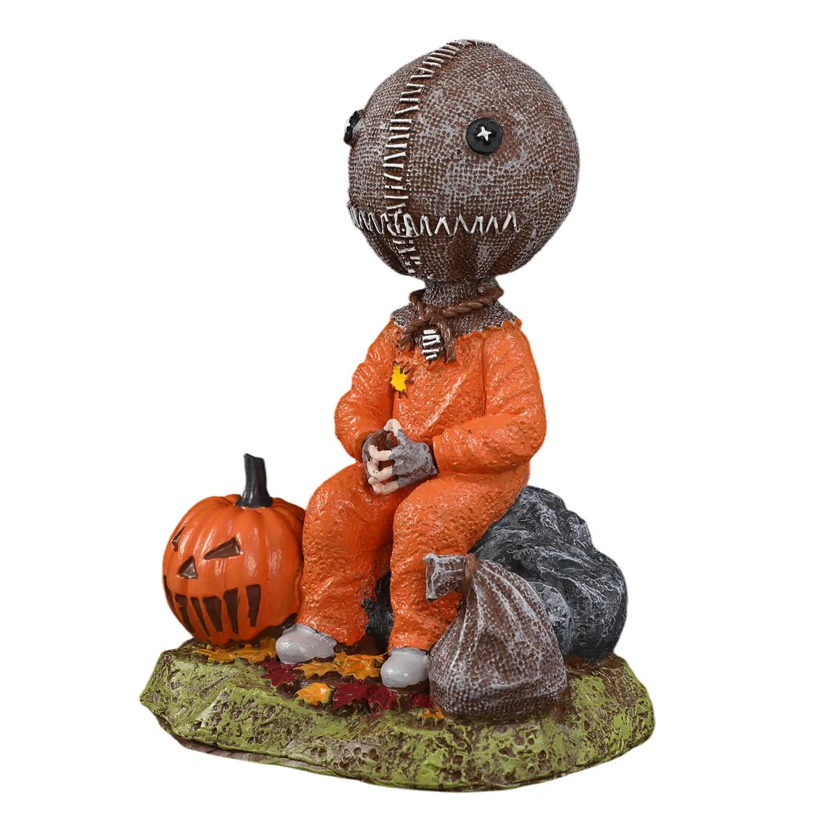 Three-quarter view of the trick-or-treat child figurine shows the stitched head, orange outfit, pumpkin, and sack.