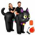 Two adults wear the linked black cat inflatable costume with rainbow connector centered between them.