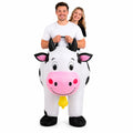 Two adults wearing the connected black and white inflatable cow costume