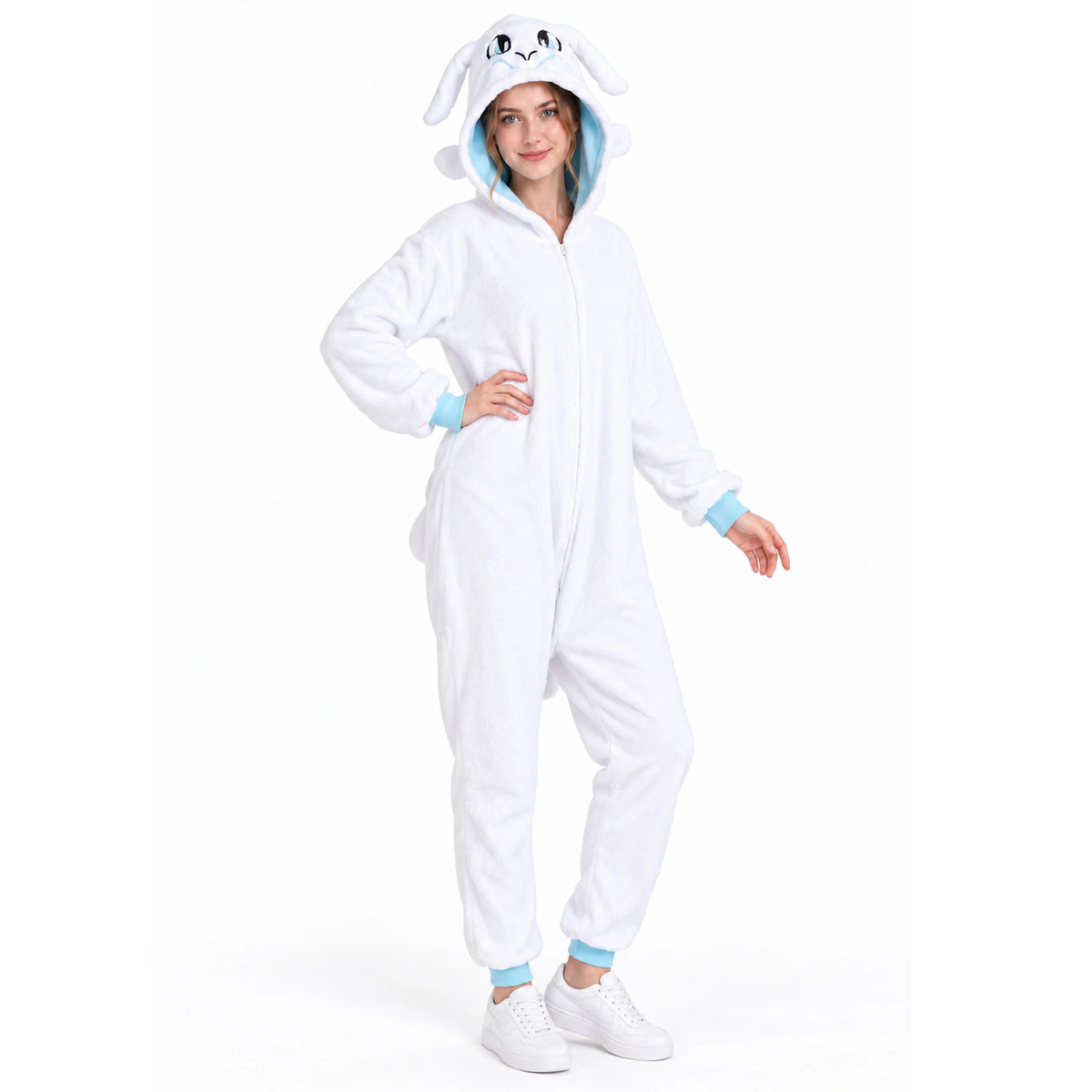Full-length view of a model with one hand on her hip in the white dragon onesie with pale blue cuffs.