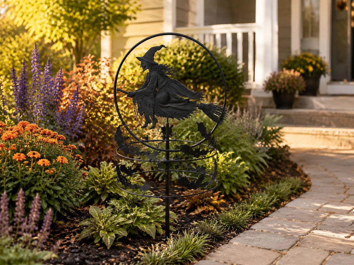 Black witch garden spinner displayed in a bright landscaped front yard